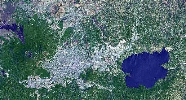 Lake Ilopango is a crater lake that fills a volcanic caldera in central El Salvador, immediately east of the capital city San Salvador. Quetzaltepec is the stratovolcano just west of the city. Its last eruption in 1917 sent lava flowing down the northwest flank and evaporated the crater lake. Image courtesy of NASA.